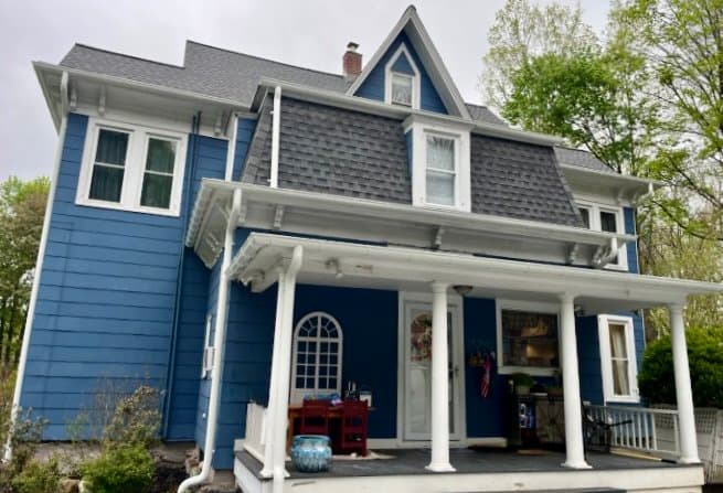 Victorian home with new grey roof navy blue siding white trim Eastchester New York